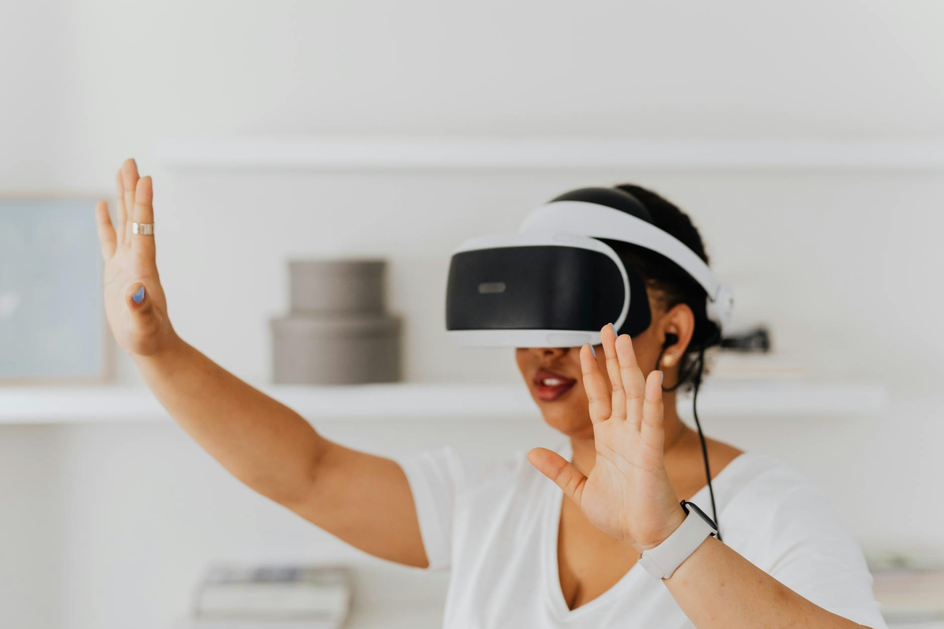 Adult woman using virtual reality headset indoors with hand gestures.